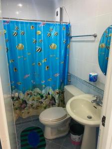 uma casa de banho com uma cortina de chuveiro com um peixe em ROMY'S PLACE - ENTIRE 3RD FLOOR APARTMENT em Vigan