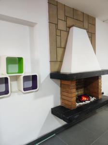 a fireplace in a room with two televisions on the wall at Hotel Montefiore in Bogotá