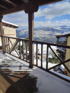 una vista dal balcone di una casa nella neve di Evergreen Suites a Synikia Mesi Trikalon