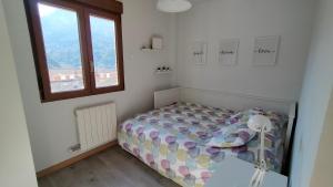 a small bedroom with a bed and a window at Peñas de Arnedillo in Arnedillo