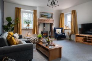 a living room with a couch and a coffee table at Brow Top Cottage, Penrith, Lake District in Skelton