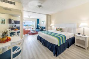 a hotel room with a bed and a dining room at La Vista Resort in Simpson Bay