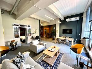 a living room with a couch and a table at No load-shedding Spacious Apartment in Cape Town