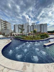 a large swimming pool in the middle of a city at Lagoa EcoTowers Resort Hotel in Caldas Novas