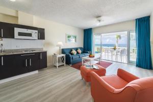 a living room with a couch and a kitchen with a view at La Vista Resort in Simpson Bay