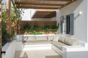 a living room with a couch on a patio at Aba Ηospitalité, The Deluxe Suite, Naousa in Naousa