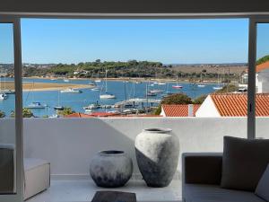 two vases sitting on a balcony with a view of a harbor at Alvor River & Sea View in Alvor