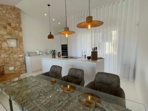 a living room with a glass table and chairs at Alvor River & Sea View in Alvor