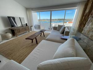 a living room with a couch and a tv at Alvor River & Sea View in Alvor