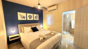 1 dormitorio con cama grande y ducha en VILLA SHUNIT- וילה שונית by barak royal suites en Eilat