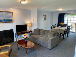 a living room with a couch and a table at Taber Inn in Mystic