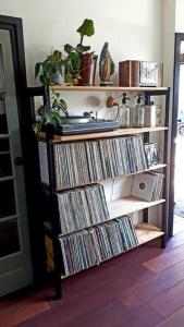 een boekenplank vol cd's in een kamer bij Onthaast & Geniet in Den Helder
