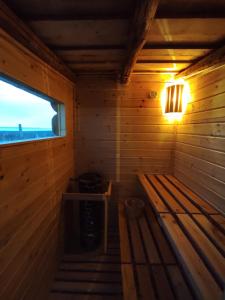 an inside of a wooden sauna with a window at Napraszállás Vendégház in Balatonakali