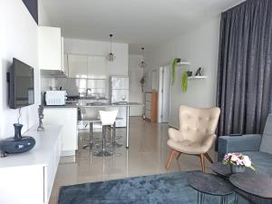 a kitchen and living room with a couch and a chair at Northern Cyprus Trikomo, Iskele, Long Beach, Caesar Resort 3 in Trikomo