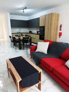 sala de estar con sofá rojo y mesa en 2 Bedroom Apartment in San Gwann, en San Ġwann