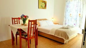 a bedroom with a bed and a table and chairs at Gregovic Apartments in Petrovac na Moru