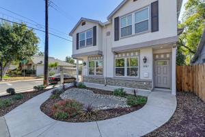 a large white house with a driveway at Sacramento Two-Story Condo Near Oak Park Brewing! in Sacramento
