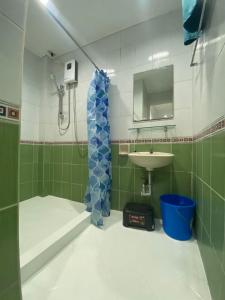 a small bathroom with a sink and a shower at ROMY'S PLACE - ENTIRE 2ND FLOOR APARTMENT in Vigan