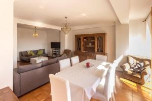 a living room with a table and a couch at Guest H4U - Povoa seaside in Póvoa de Varzim