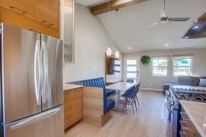 a kitchen with a stainless steel refrigerator and a table at Ocean Beach Retreat 2BR Newly Remodeled, 2 Blocks to Sand and Shops in San Diego