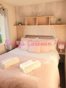 a bed with two towels on top of it at Becky's Caravan at Marton Mere in Blackpool