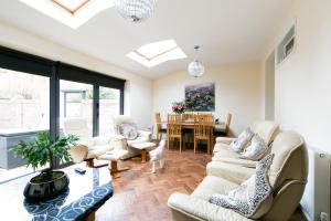 a living room with white furniture and a dining room at Shrewsbury Cottage in Shrewsbury