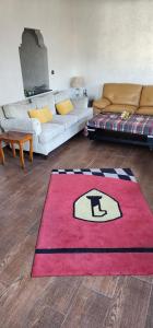 a living room with a red rug on the floor at residence baida in Casablanca