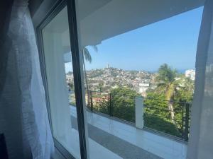 a balcony with a view of a city at Loft 208 in Acapulco