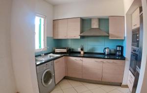 a kitchen with a sink and a washing machine at Kaza Nina - Perfect place to unplug in Santa Maria