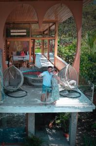 a man and a woman standing on a table at Saguamby Mindo Lodge in Mindo