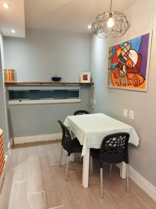 a dining room with a table and two chairs at Residencial Letícia Miranda in Aracaju