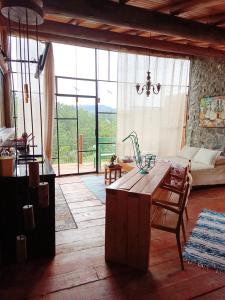 a living room with a table and a couch at Tiny Houses O Olival - aluguel temporada in Cunha