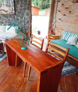 a wooden table with a funnel on top of it at Tiny Houses O Olival - aluguel temporada in Cunha