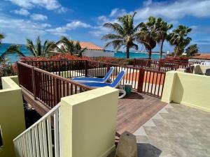 une terrasse avec une chaise bleue et l'océan dans l'établissement Porto Antigo 1 - Beach apartments, à Santa Maria
