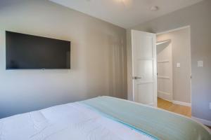 a bedroom with a bed and a flat screen tv at 7BD Family, Event Friendly, 2 blocks to Beach, Boardwalk in San Diego