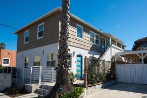 a palm tree in front of a house at 7BD Family, Event Friendly, 2 blocks to Beach, Boardwalk in San Diego