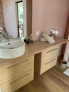 łazienka z umywalką i lustrem w obiekcie Maison Origine Périgueux w mieście Périgueux