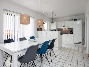 a kitchen and dining room with a white table and chairs at Luxury Spa Retreat by Sea in Humble
