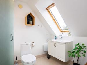 a bathroom with a white toilet and a sink at Luxury Spa Retreat by Sea in Humble +37 photos