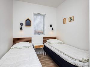 a bedroom with two beds and a desk and a window at Luxury Spa Retreat by Sea in Humble