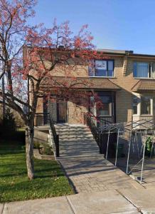 a brick house with a staircase in front of it at Heaven Is A Place On Earth in Montréal
