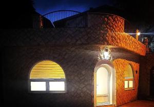 a building with two arched windows at night at Apartman Kedar in Arandelovac