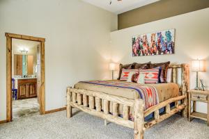 a bedroom with a wooden bed and a mirror at Vista Linda Cabin in Angel Fire