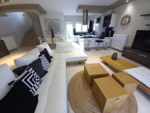 a living room with a white couch and a table at Homing Volos Exclusive Luxury Residence in Volos