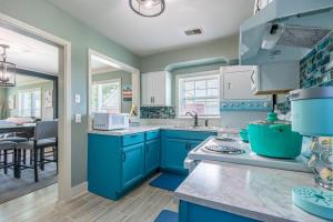 a kitchen with blue cabinets and a counter top at MIKA SPRINGS Beach Inspired Home! in Memphis