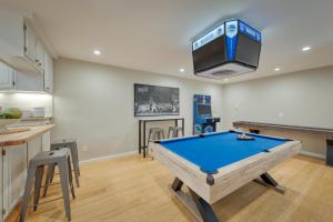 a room with a pool table and a tv at Game On! in Novato