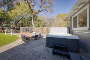 a backyard with a hot tub and two chairs at Game On! in Novato