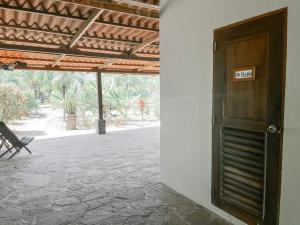 a door with a sign on it next to a patio at Mar Adentro Sanctuary in Tola