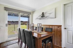 a dining room with a wooden table and chairs at Putty's @ Marengo in Marengo