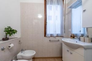 un bagno bianco con un water e un lavandino di Suite 1,2 porta Milano centro parking free a Milano Altre 15 foto